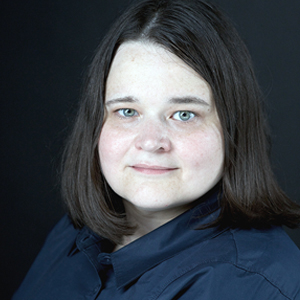 Headshot of Upshot editor Amanda Cox, a pale white woman with brunette hair and blue eyes. She is wearing a navy blue button down shirt.